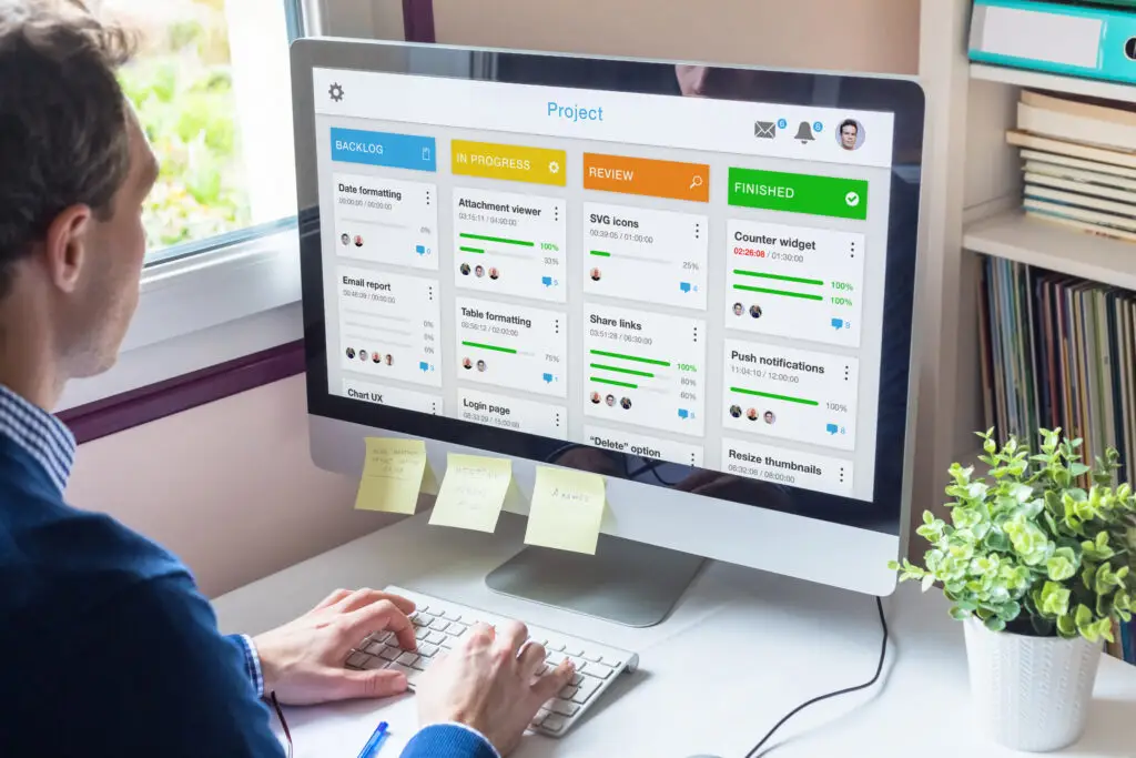 Manager working with agile product development using scrum or kanban methodology, lean project management framework with iterative or incremental strategy, person with computer in office