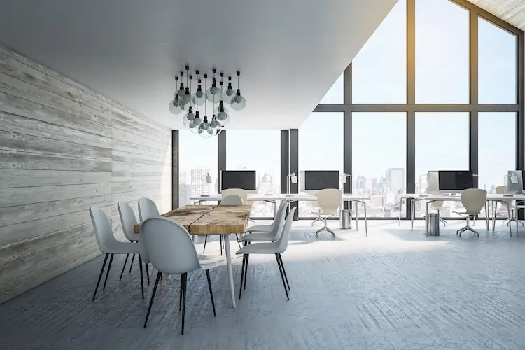 Minimalistic coworking office interior with computers, wooden wall and panoramic city view. Workplace and company concept.