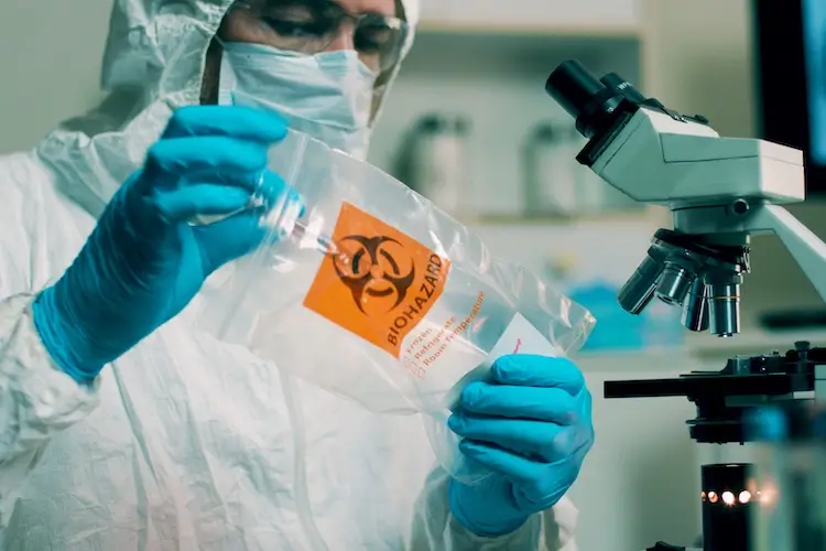 medium shot lab tech with sample of virus.