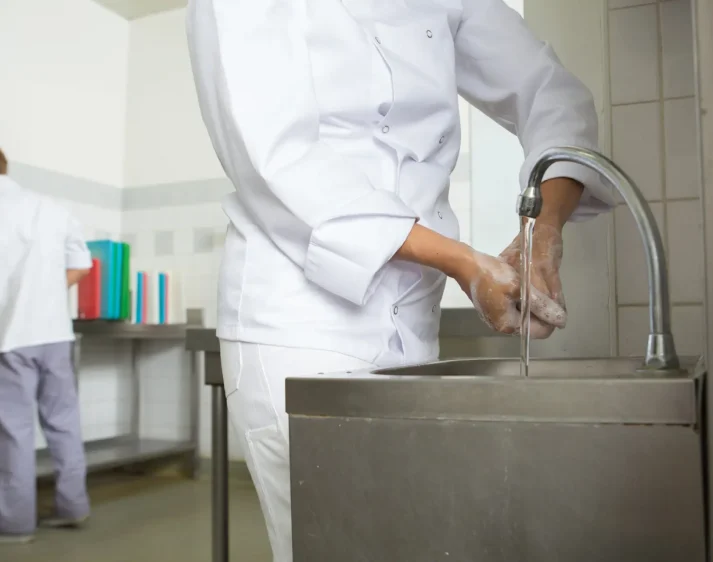 chef washing his hands prior to cook.